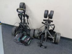 Two folding electric golf trolleys,