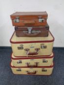 A set of three 20th century airport lightweight luggage cases together with two further vintage