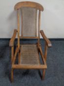 A 20th century teak and bergere steamer armchair