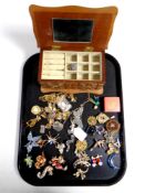 A tray of costume brooches,