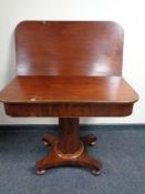 A Victorian mahogany pedestal turnover top tea table on bun feet