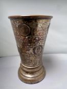A 19th century copper plated drinking vessel, embossed with George III 1807 coins,