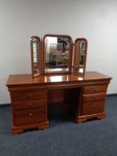 An Olympus Furniture cherry wood knee hole dressing table fitted drawers with triple mirror