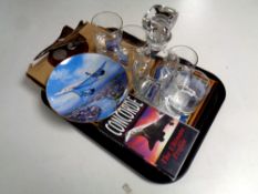 A tray containing Concorde memorabilia to include framed first day cover, decanter and glasses,