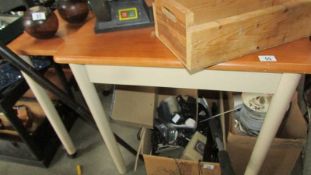 A teak effect table with pull out leaf.