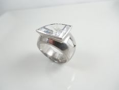 Silver ring with white stone.