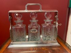 Silver-plated tantalus with three cut crystal decanters
