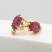 A boxed pair of 18ct yellow gold treated ruby and diamond ear studs