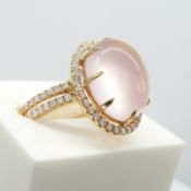 An exquisite large Cabochon rose quartz and Diamond halo ring with split Diamond shoulders