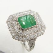 A superb, octagonal Platinum 1.85 carat Emerald and 1.20 carat double-Diamond halo ring