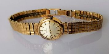 A mid-20th century ladies Omega dress watch with 9ct gold case and strap, hallmarked, inscribed,