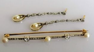 An Art Deco diamond and pearl bar brooch, 70mm. with a pair of near matching earrings, each 50mm,