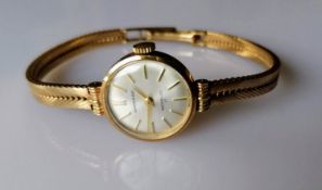 A Garrard mid-century ladies 9ct gold presentation watch with baton numerals, in working order,