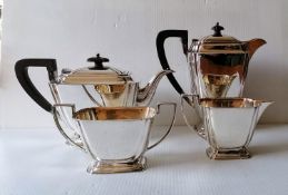 An Art Deco silver four-piece tea/coffee service with stylized design, reeded handles on stepped