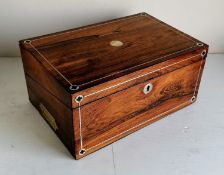 A 19th century rosewood writing slope with mother of pearl string inlay, recessed brass handles,
