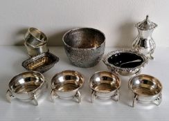 An Art & Crafts set of four circular silver salts with stylised handles by Sibray, Hall & Co Ltd.,
