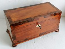 A Georgian mahogany and rosewood crossbanded tea caddy with ivory escutcheon, fitted interior with