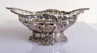 An oval Victorian pierced silver basket with C-scroll decoration by William Comyns, London, 1890,
