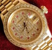 A Rolex ladies 18K gold diamond and ruby-set automatic wristwatch, with centre sweep seconds hand,