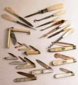 An assortment of eleven Edwardian mother-of-pearl and ivory-handle pen knives, some with