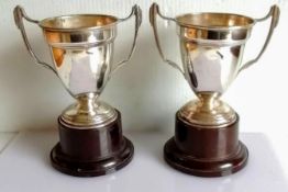 A pair of Art Deco two-handled trophy cups on bakelite bases by Alexander Clark & Co Ltd.,