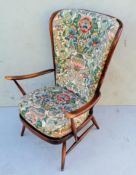 An Ercol beechwood Windsor stick-back armchair with swept arms, loose cushions, splay legs and
