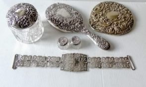 A late Victorian silver-backed hand mirror with rococo decoration by Goldsmiths & Silversmiths