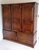 A Harrods Royal Oak Furniture three-door cupboard with drawers under, fitted for hanging, 196 h x