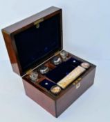 A Victorian mahogany vanity box with silver plate topped bottles/jars, fitted interior, secret