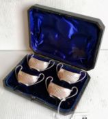 A Victorian cased set of four silver salts with half-fluted decoration, twin handles by James