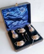An Edwardian cased silver condiment set comprising two salts, mustard, salt, pepper with three