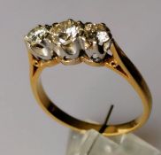 A three-stone diamond ring, the brilliant-cut graduated diamonds measuring 0.50, 0.25 (x2) carats,