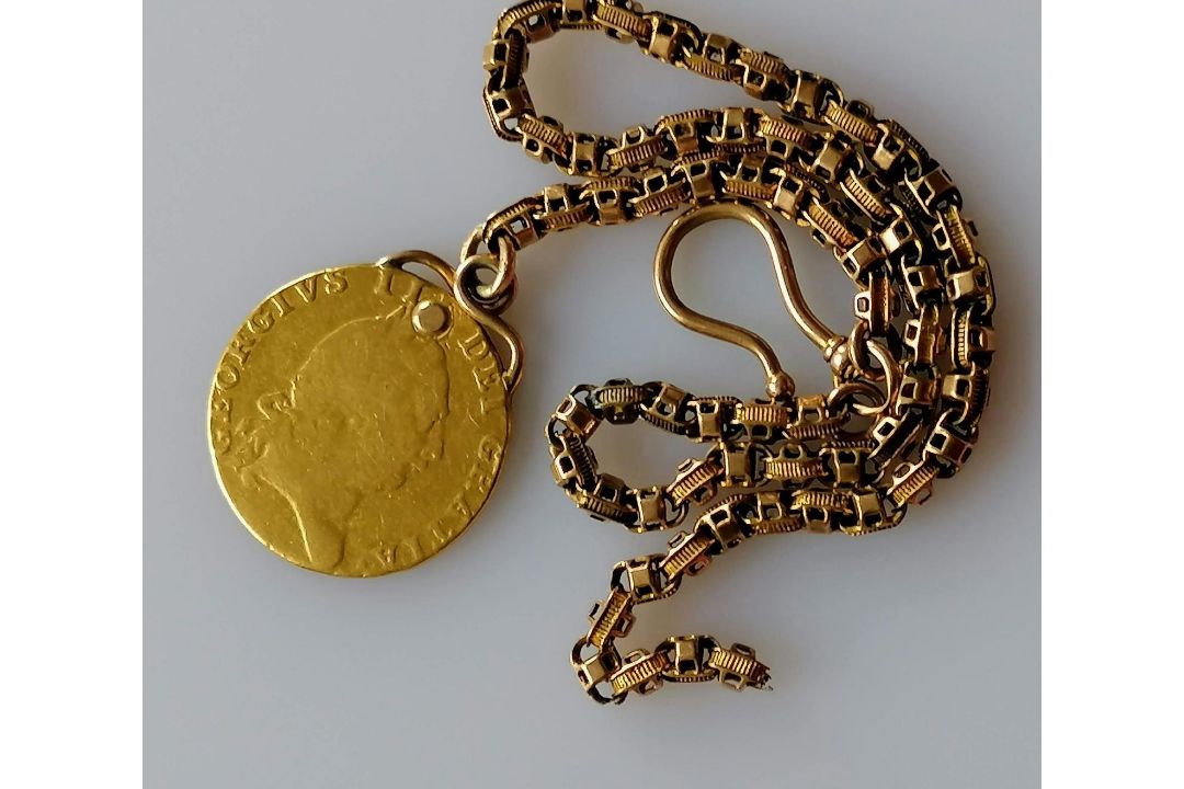 A George III gold sovereign, 1788, 8.6g on a gold chain, tests for gold, 9.65g. (total weight 18. - Image 1 of 2