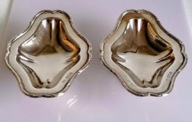 A pair of George V silver tazze with decorated borders, each on a spreading foot by Skinner & Co.,