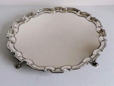 A George II silver salver with pie-crust border on four hoofed feet, initialled to underside, by