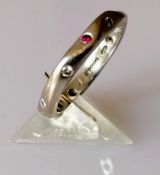 A Jeremy Hoyle carved 18ct white gold ruby and diamond eternity ring, size K 1/2, hallmarked, 3.81g