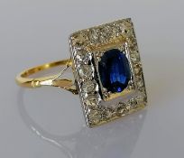 An Art Deco oval-cut sapphire and diamond cluster ring on an 18ct yellow gold setting: the
