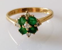 An emerald and diamond cluster ring: estimated total emerald weight 0.45 carats, diamonds 0.12