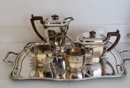 An Art Deco silver four-piece tea/coffee service with egg and dart decoration to rim, faceted sides,