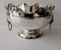 A George V silver monteith with shaped rim, carved mask decoration, moulded girdle, flanked by