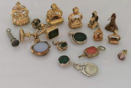 An assortment of eighteen fobs, many carnelian, some bloodstone with carved names, insignia, etc