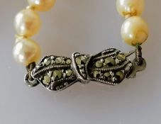 An Art Deco single row of eighty graduated Akoya cultured pearls, measuring 4.4mm to 8.1mm on an 800
