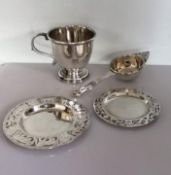 A George V silver christening mug on a stepped base, 7.5 cm H, marks rubbed; a tea strainer by