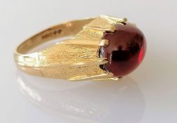 A mid-century 9ct gold gypsy ring with garnet cabochon, size R, hallmarked, 6.07g