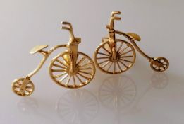An artisan gold pair of cuff links in the form of penny farthings, unmarked, testing for 18ct, 9.8g