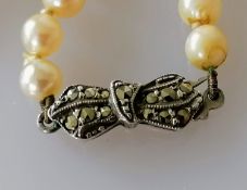 An Art Deco single row of eighty graduated Akoya cultured pearls, measuring 4.4mm to 8.1mm on an 800
