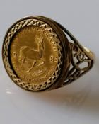 A 1/10th Krugerrand coin, 1985, on a pierced 9ct gold mount, size O, hallmarked, 6.09g