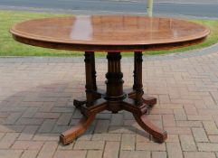 A late Victorian Gillows oval burr walnut centre table with crossbanding and decorative inlay on a
