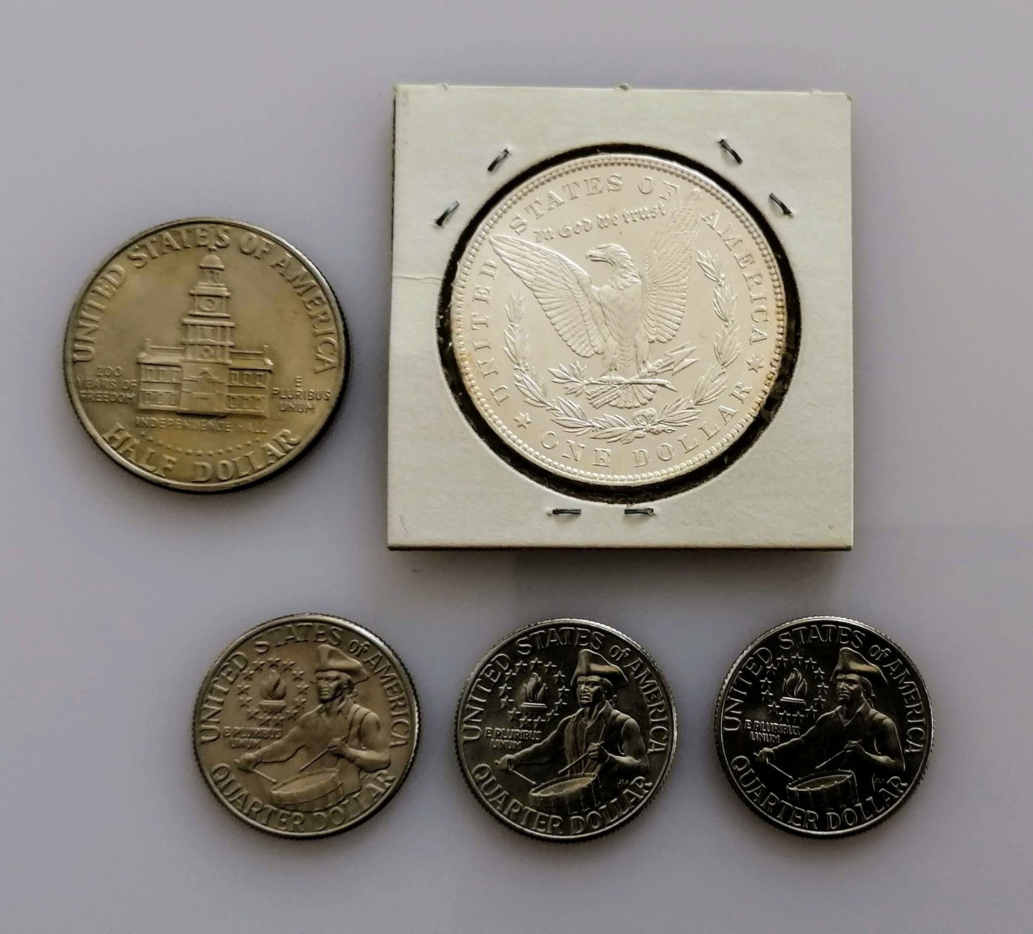 An 1886 Morgan one dollar coin, graded MS-60; three 1776-1976 quarter dollar coins, Denver mint - Image 2 of 4