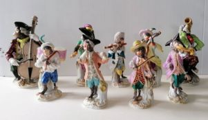 A Meissen monkey band comprising seven monkeys in 18th century costume each standing on a scroll